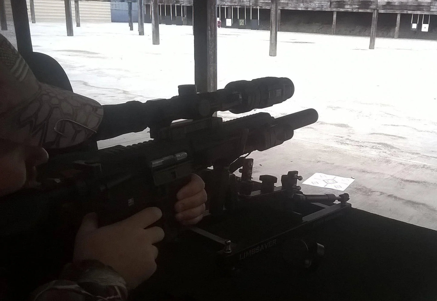 Shooter aiming rifle with Bering Optics Hogster C 384 thermal clip-on scope at outdoor range