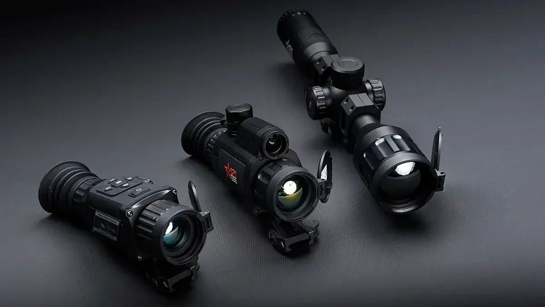 Three thermal rifle scopes displayed on a dark surface, lens covers open, tactical optics