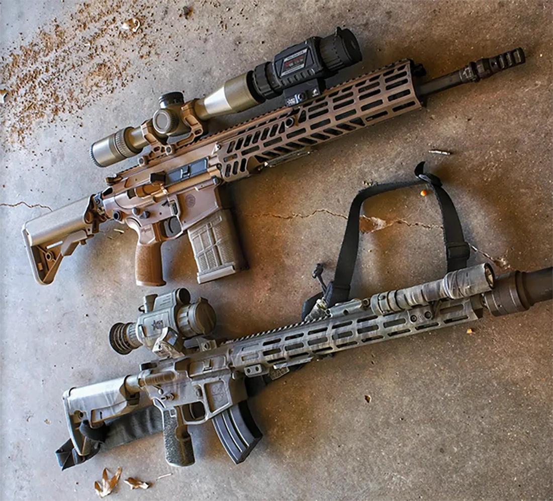 Two rifles on concrete, one with a dedicated thermal scope, the other with a thermal clip-on.