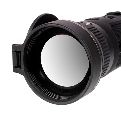 Close-up of a night vision scope lens with black textured housing